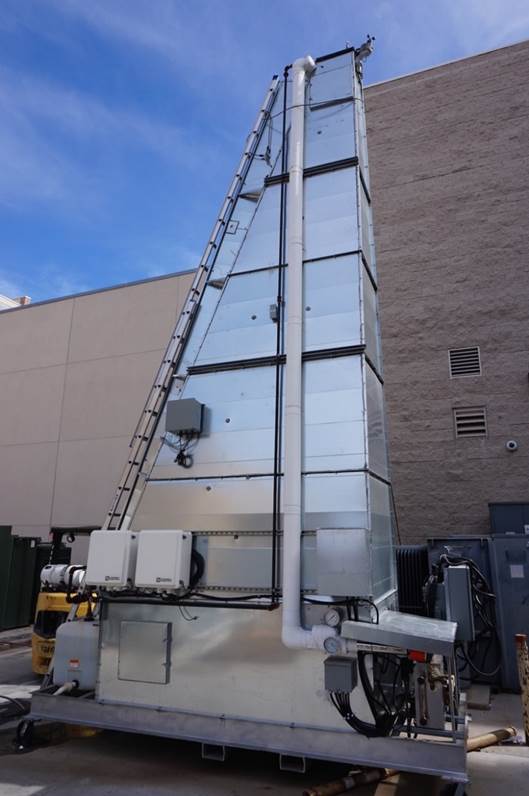 A dry cooling system, triangular in shape, and standing about two stories tall