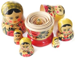 Nesting Matryoshka dolls with the top halves removed and arranged so that smallest doll can be seen.