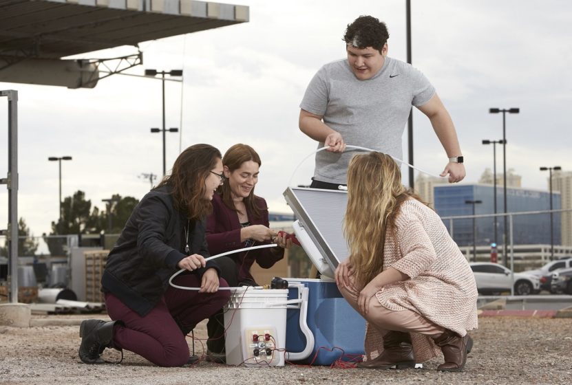 Erica Marti works with UNLV students to assemble a portable solar energy classroom kit