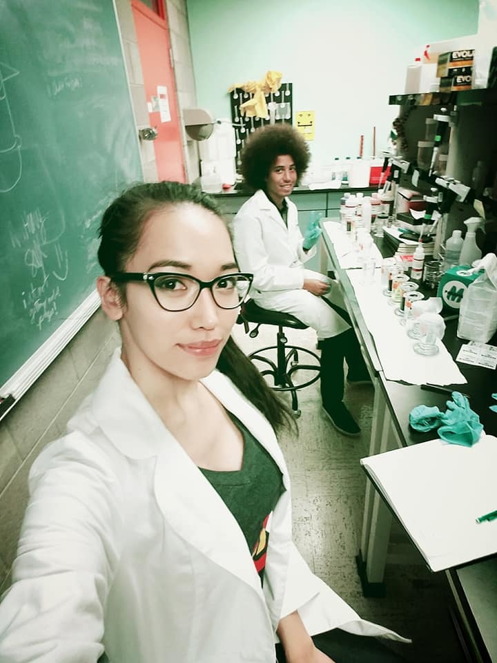 A pair of student scientists pose for a selfie in a classroom lab.